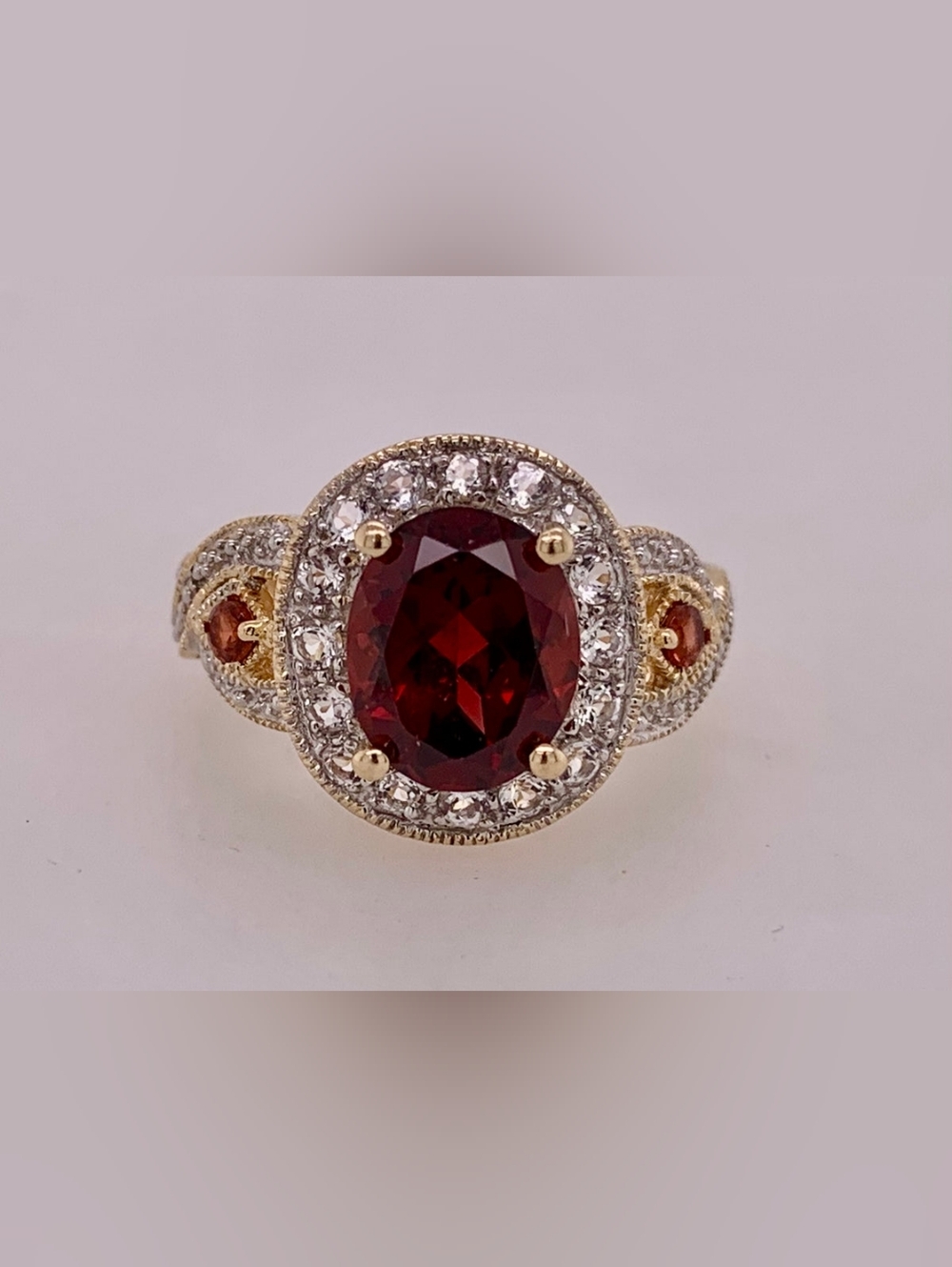 Wieck 14k Yellow Gold Ring with Oval Garnet Surrounded By White Sapphires.